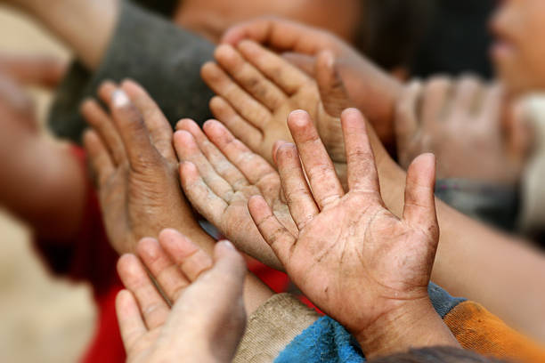 istock Children raising hands, begging for food in a developing country 496256998