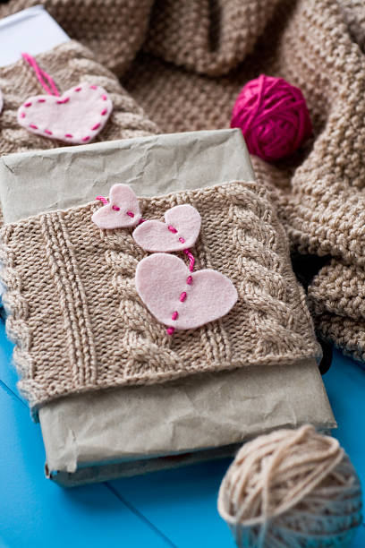 istock Two old pads in knitted cover with felt hearts 496257048