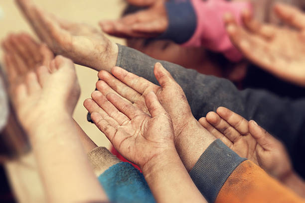 istock Poor children with hands raised begging for food 496257062