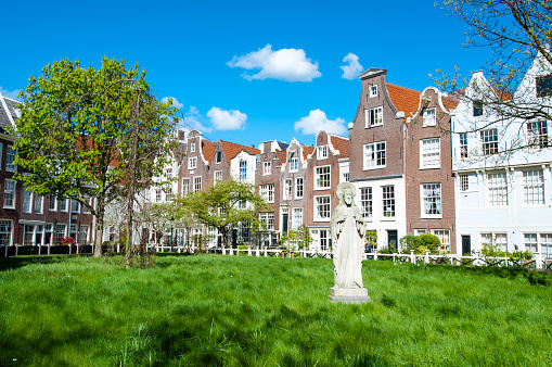 Amsterdam, the Netherlands - April 30, 2015: The Begijnhof courtyard during the sunny day.