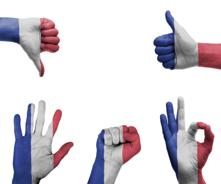 A set of hands with different gestures wrapped in the flag of France