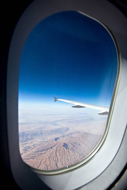 istock View at the earth from window of airplane 496260960