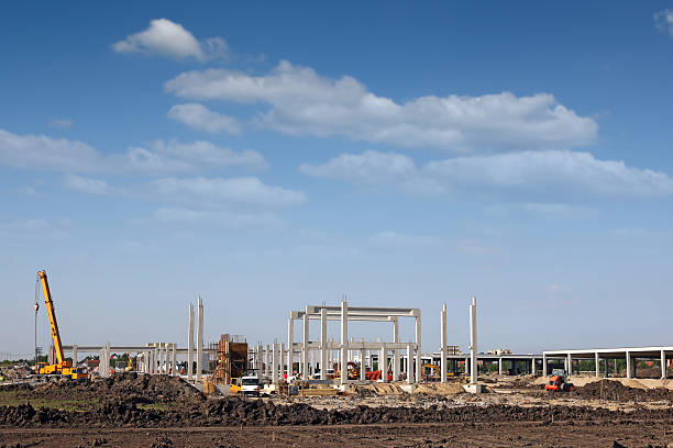 istock shopping mall construction site with workers and machinery 496261124