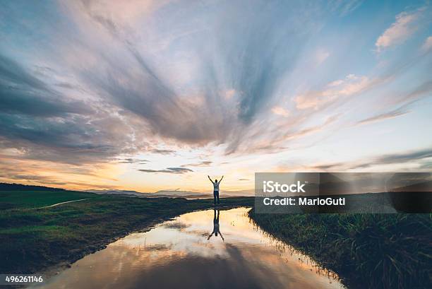 Young Man At Sunset Stock Photo - Download Image Now - Hope - Concept, Freedom, Praying