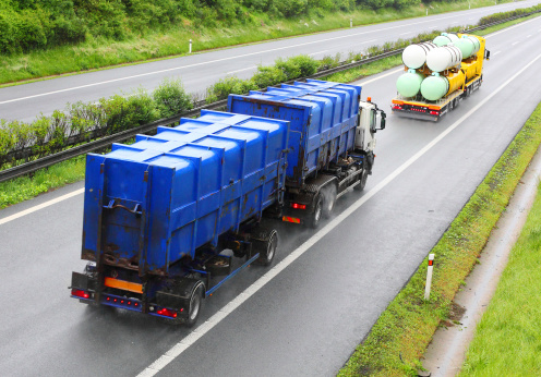 Trucks with toxic waste on the highway. Industry and pollution concept.