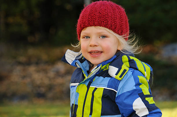 istock little boy laughing outdoors 496261891