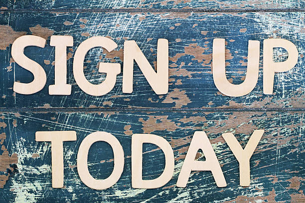 istock Sign up today written on rustic wooden surface 496261978