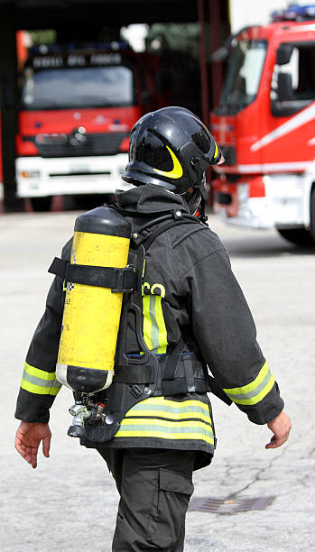 istock firefighter with yellow oxygen cylinder and the helmet 496262097