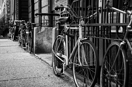 New York City, USA - May 17, 2014: A row of stored and locked bicycles seen outside a building in Manhattan. 