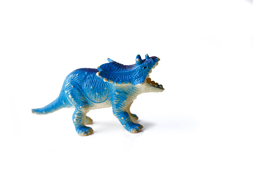plastic figure of menacing dinosaur with open mouth, isolated on white background