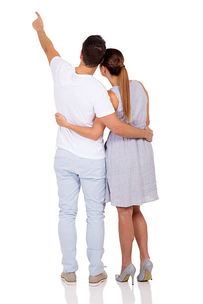 istock rear view of married couple pointing 496265912