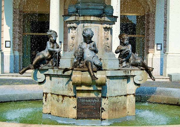 statue of boys holding fish in fountain