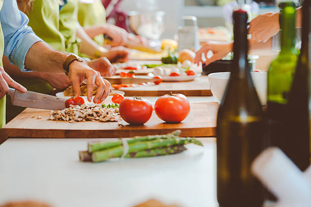 istock People taking part in cooking class, slicing vegetables 496266372