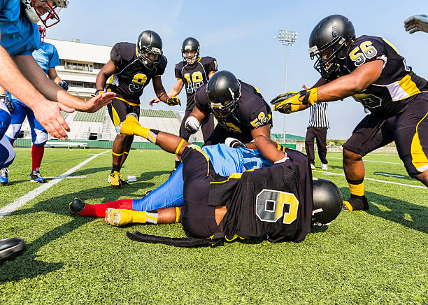 istock Football Players Tackle an Opposing Player 496266409
