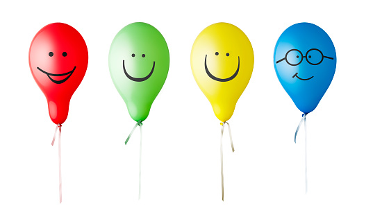 Family of coloured balloons with drawn faces on a white background with clipping path