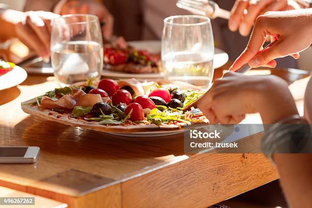 Woman Eating Pizza In The Restaurant Stock Photo - Download Image Now - 2015, Adult, Bar - Drink Establishment