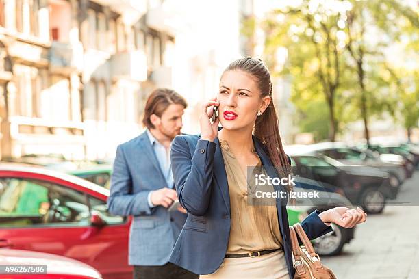Young Businesswoman Talking On Phone Outdoors Stock Photo - Download Image Now - 2015, Adult, Adults Only