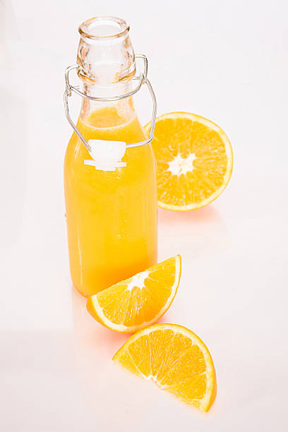istock Orange juice with a sliced orange and orange quarters 496268922