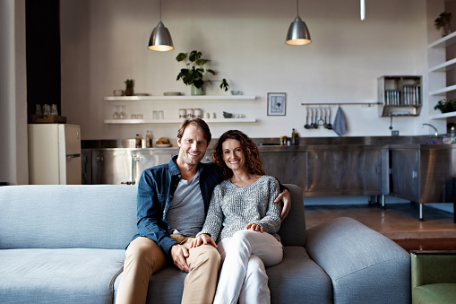 Portrait of a smiling mature couple sitting on a sofa in their living room