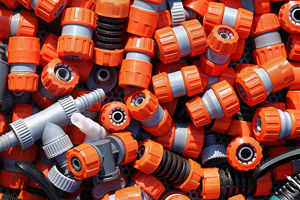 Large pile of plastic garden hose fittings