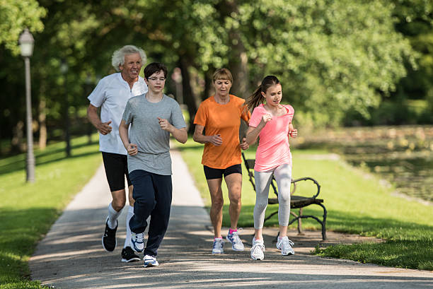 istock Family jogging in park 496277918