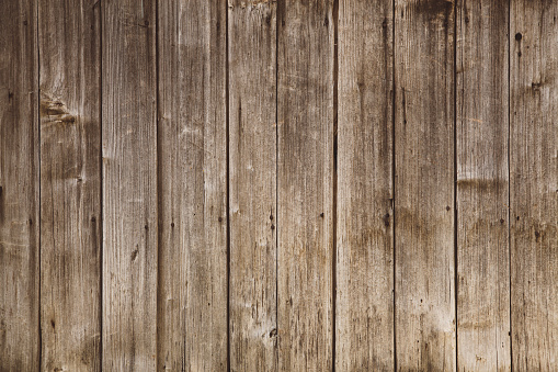 Texture of an old wooden barn door. Vintage toned image, Taken with Canon full frame camera. Image suitable for backgrounds, textures, copy space.
