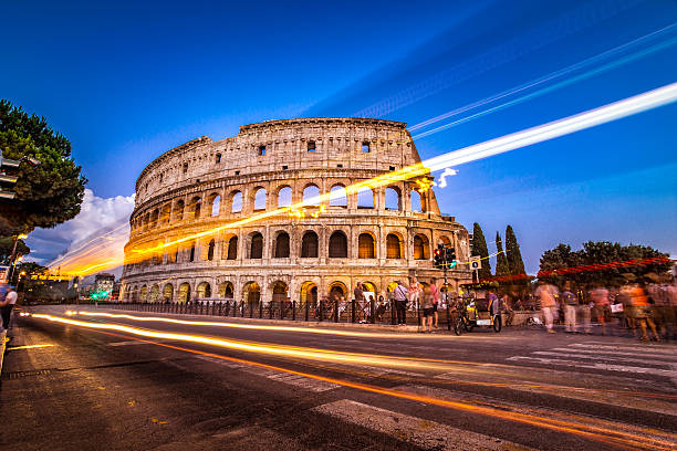 istock Colosseum in Rome, Italy by twilight with traffic light trails. 496279190