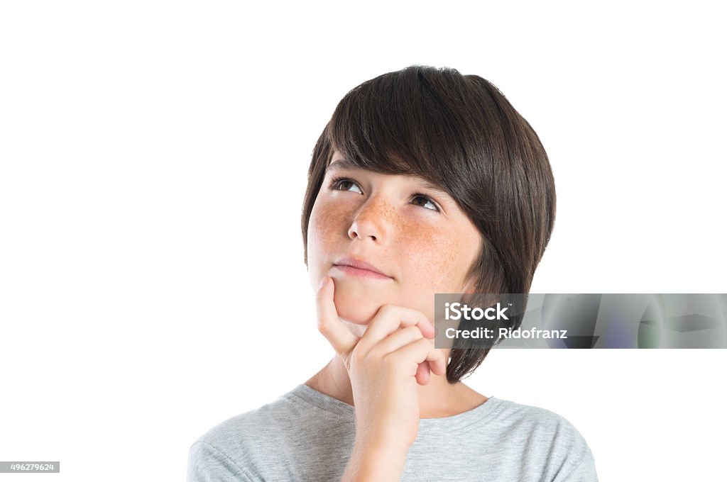 Pensive boy Portrait of cute boy thinking isolated on white background. Closeup shot of boy thinking with hand on chin. Male child with freckles looking up and contemplates isolated on white background. Contemplation Stock Photo
