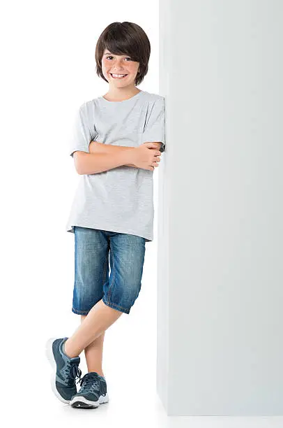 Photo of Happy boy against blank sign