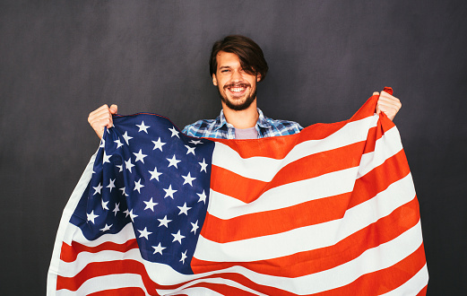A man holding the american flag.