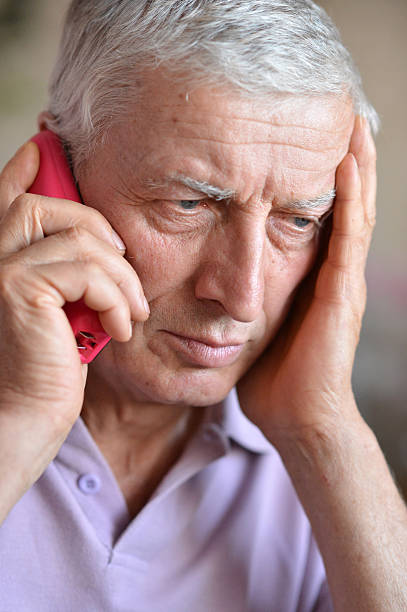 istock elderly man calling to the doctor 496281388