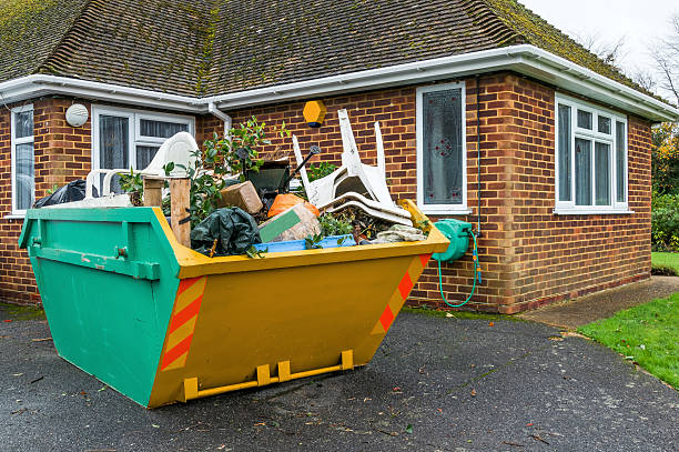 Full rubbish skip A full rubbish skip beside a house that has been filled up by the householder. industrial garbage bin photos stock pictures, royalty-free photos & images