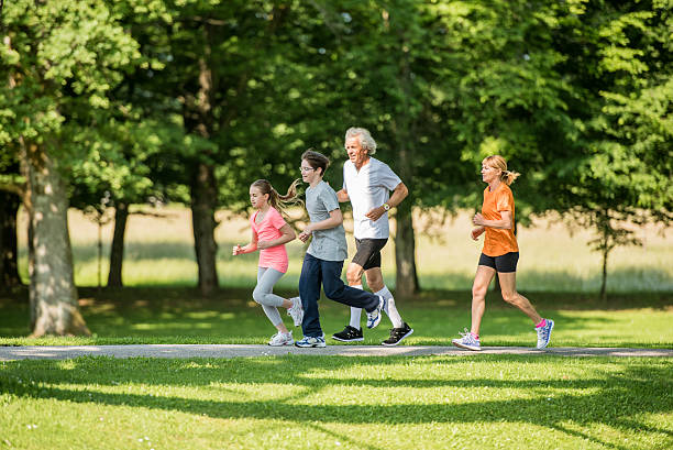 istock Family jogging in park 496282438
