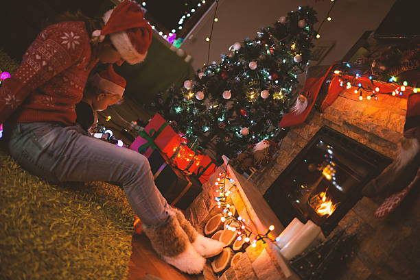 istock Mother and son by a fireplace on Christmas night 496284438