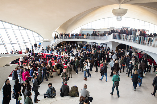 New York City, New York, USA - October 18, 2015: View of crowd at the historic  TWA Flight Center airport terminal at John F. Kennedy International Airport during the 2015 OHNY event.  OHNY is an annual event that allows visitors access to historic buildings such as this that are typically closed to visitors. The TWA terminal at JFK closed for business in 2001. 