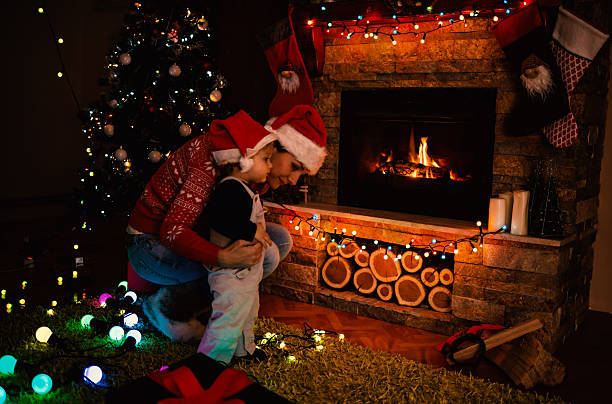 istock Mother and son by a fireplace on Christmas night 496285050