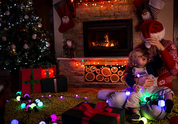 istock Mother and son by a fireplace on Christmas night 496285422