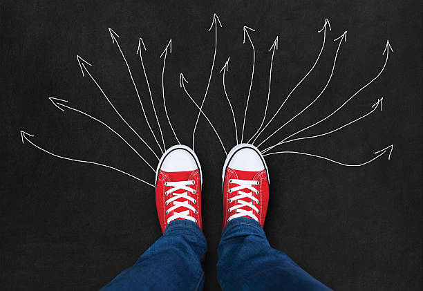 istock Feet wearing red shoes with arrows. choice 496285870
