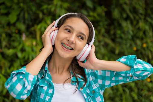 Close-up lifestyle outdoor portrait of a teenage girl and headphones 