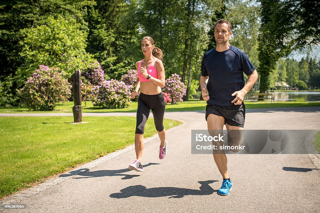 Couple jogging in park Couple jogging together in park. 2015 Stock Photo