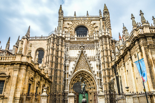Seville, Spain - August 12, 2015: The exterior of the Seville Cathedral as seen from the plaza in front. The photo was taken during a warm summer day and contains no people.