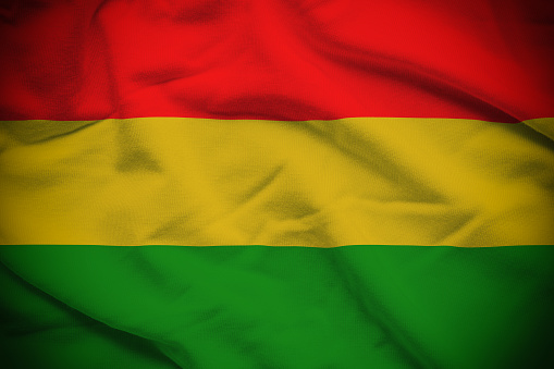 Wavy and rippled national flag of Bolivia  background.