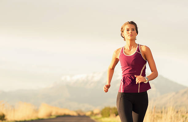 istock Young Woman Running Along Road in Utah 496291400