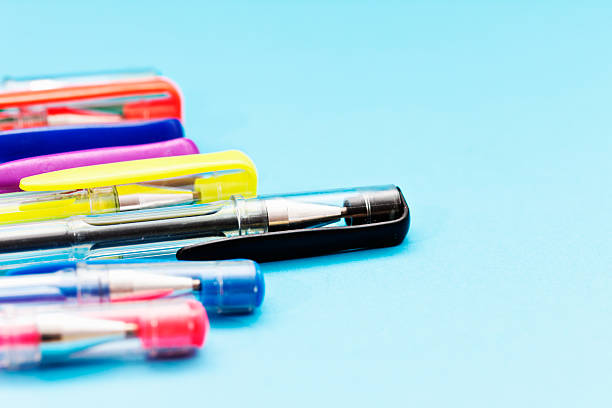 istock Rainbow of ballpoint pens in close-up on turquoise background 496306231