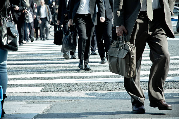 Tokyo City Commuters Tokyo, Japan - April16, 2014 Crowds of pedestrians crossing the street at Shibuya in April16, 2014, the most important commercial center in Tokyo, Japan tokyo crowds on the famous shibuya crossing japan stock pictures, royalty-free photos & images