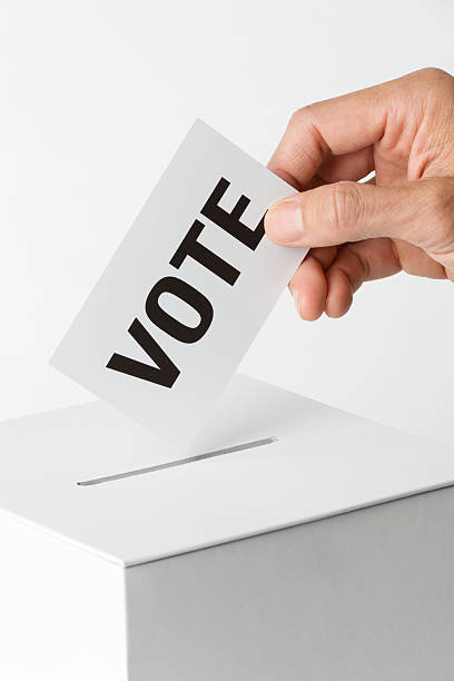 istock Election Voter Voting Ballot Over Ballot Box 496307296