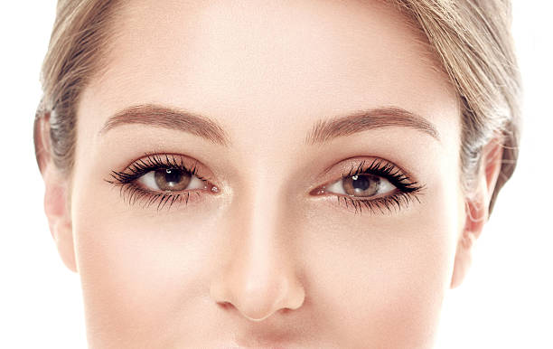 istock Eyes lashes Beautiful woman face close up studio on white 496308964