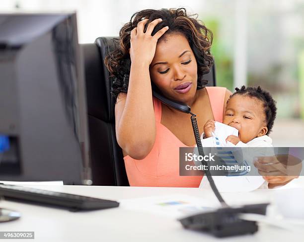 Stressed African American Businesswoman With Baby Girl In Office Stock Photo - Download Image Now