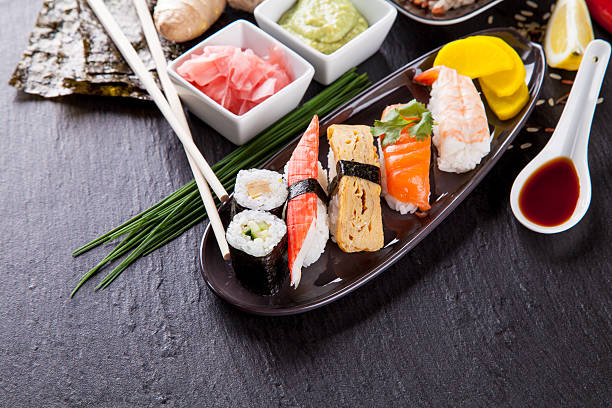 istock Delicious sushi pieces served on black stone 496309895