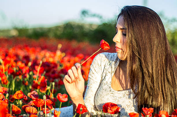 istock girl smell a poppy 496310049